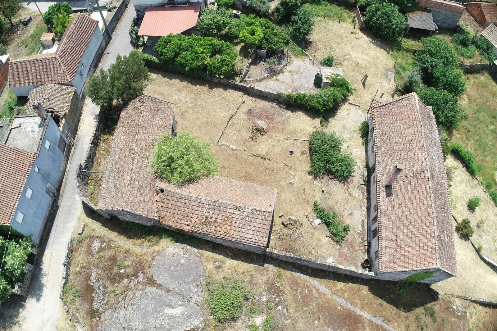 Aerial view of the courtyard and stone barns, May 2023
