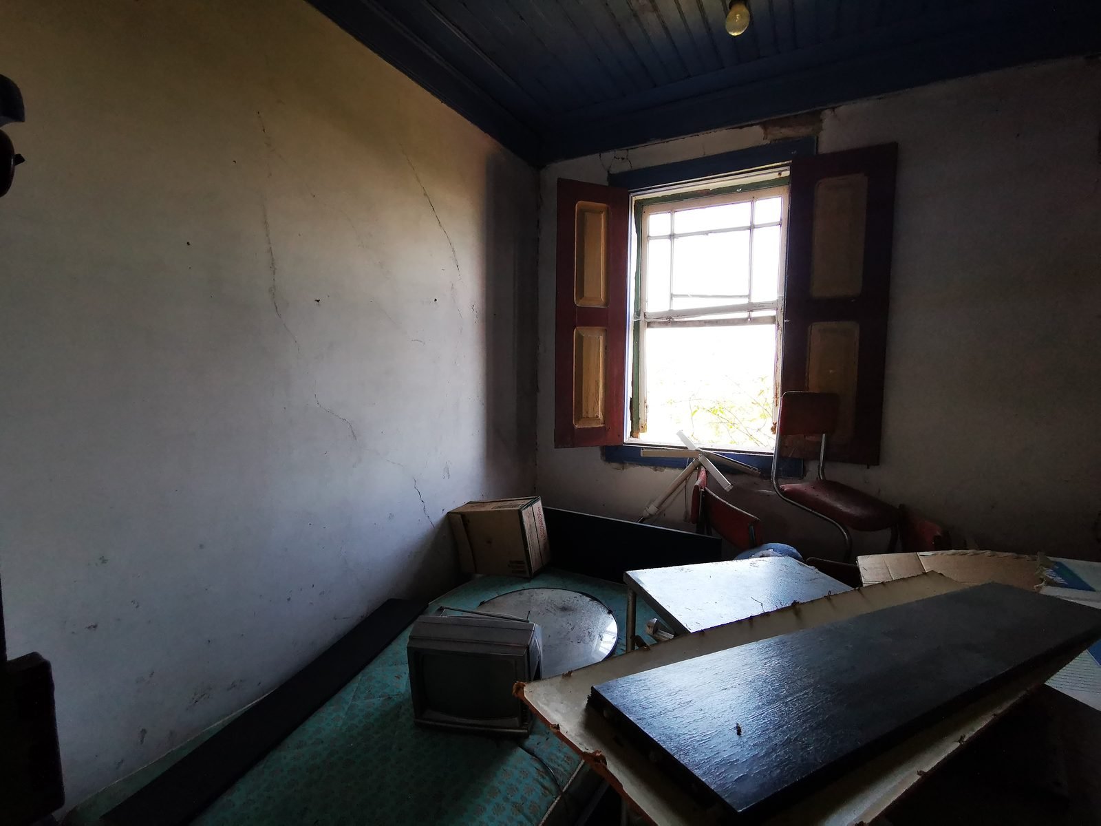 Another interior room, with decades of belongings left behind