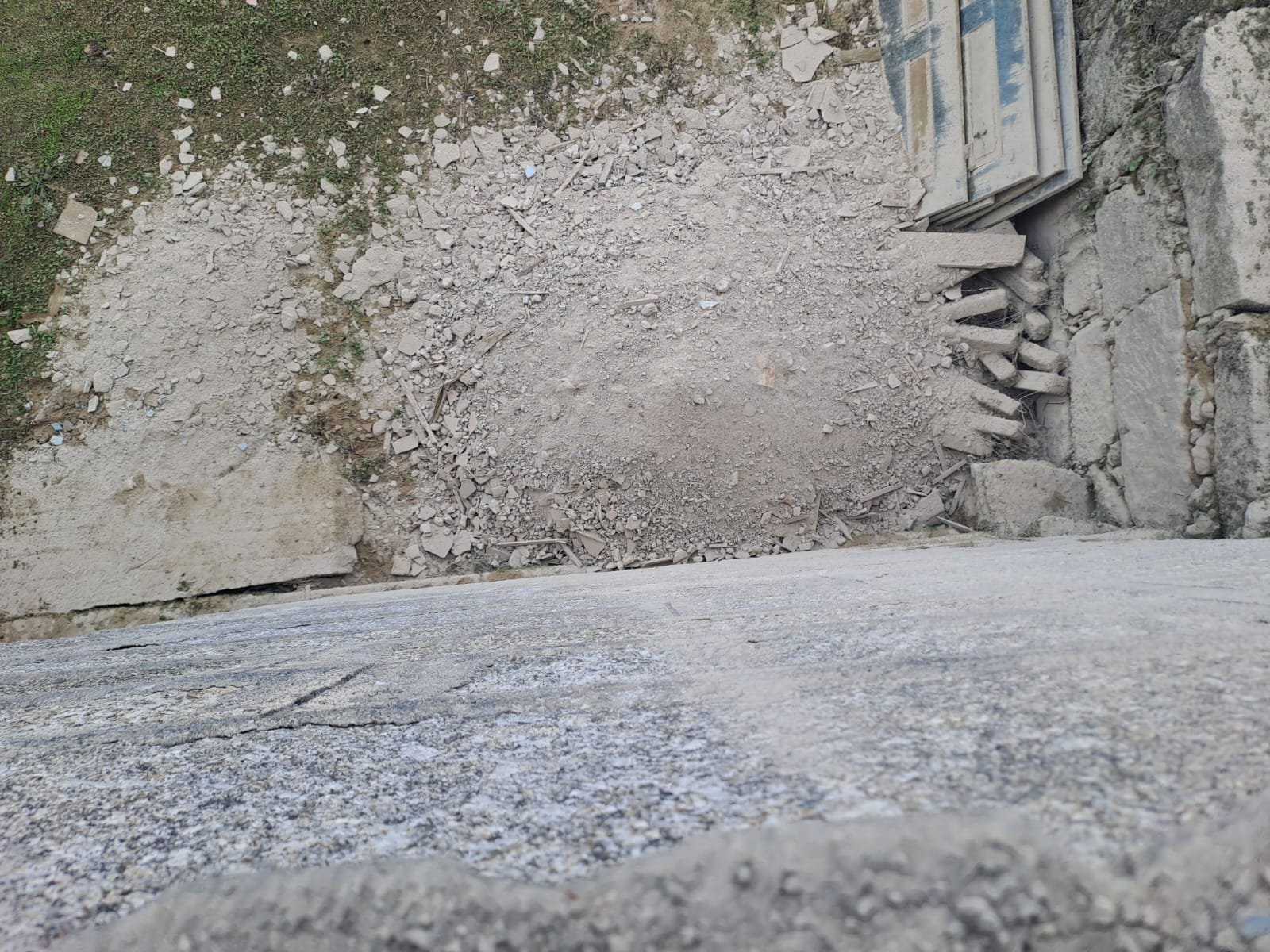 A pile of old stone and rubble against the exterior wall