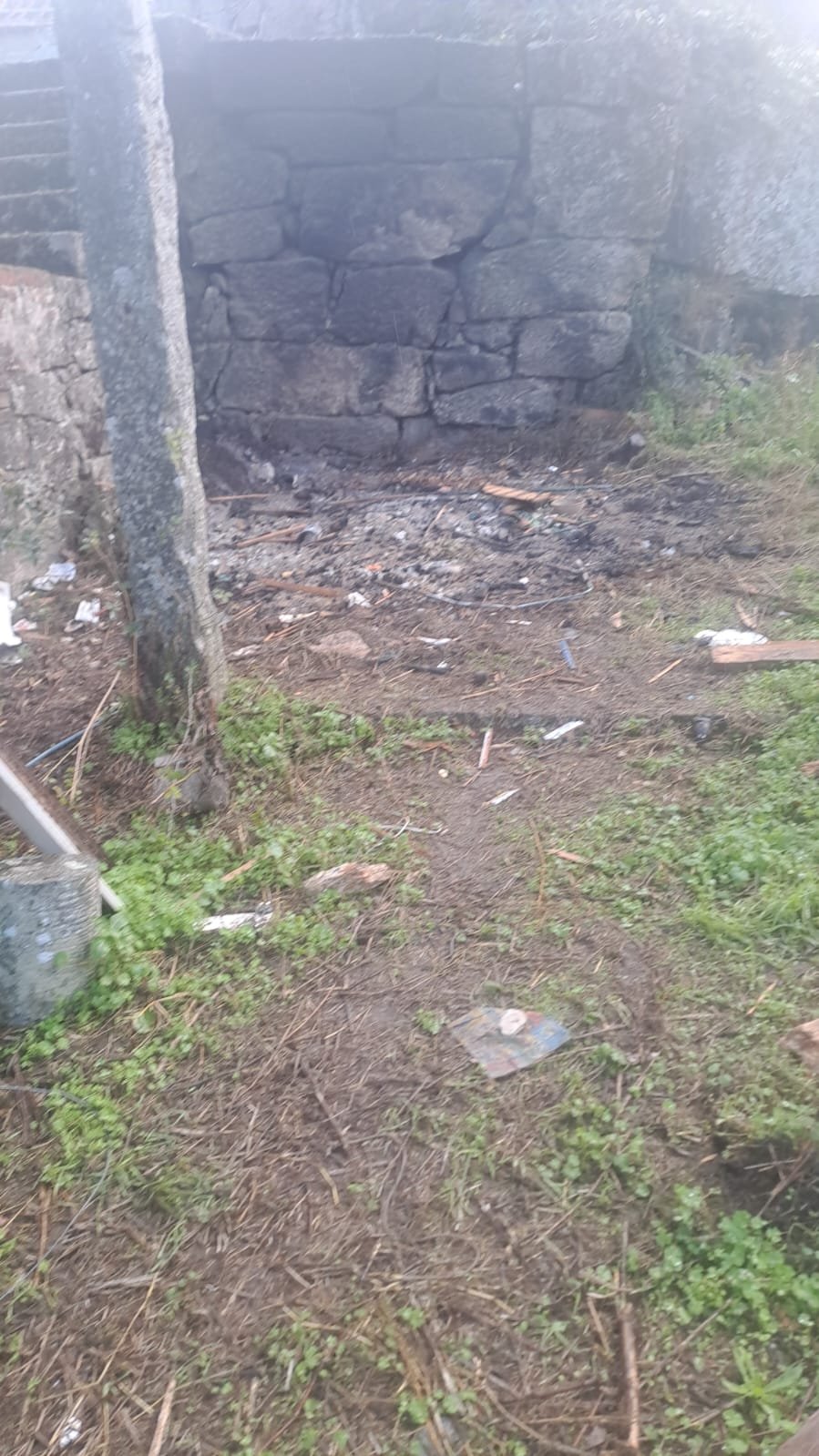 Ashes from the debris burn, morning after
