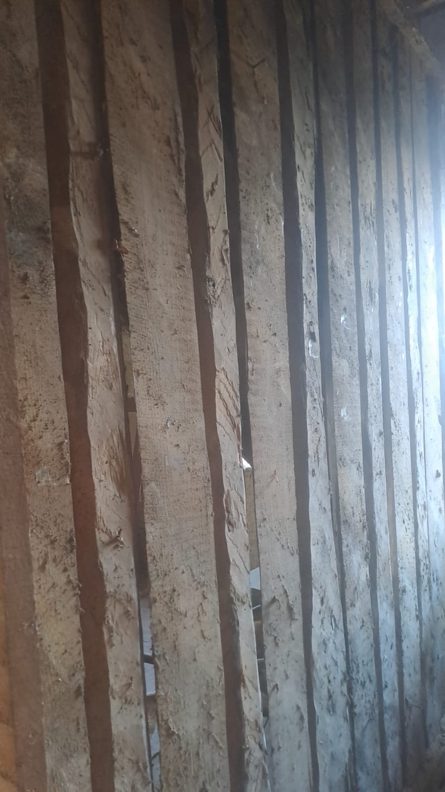 Close-up of the exposed wood lath under the old plaster