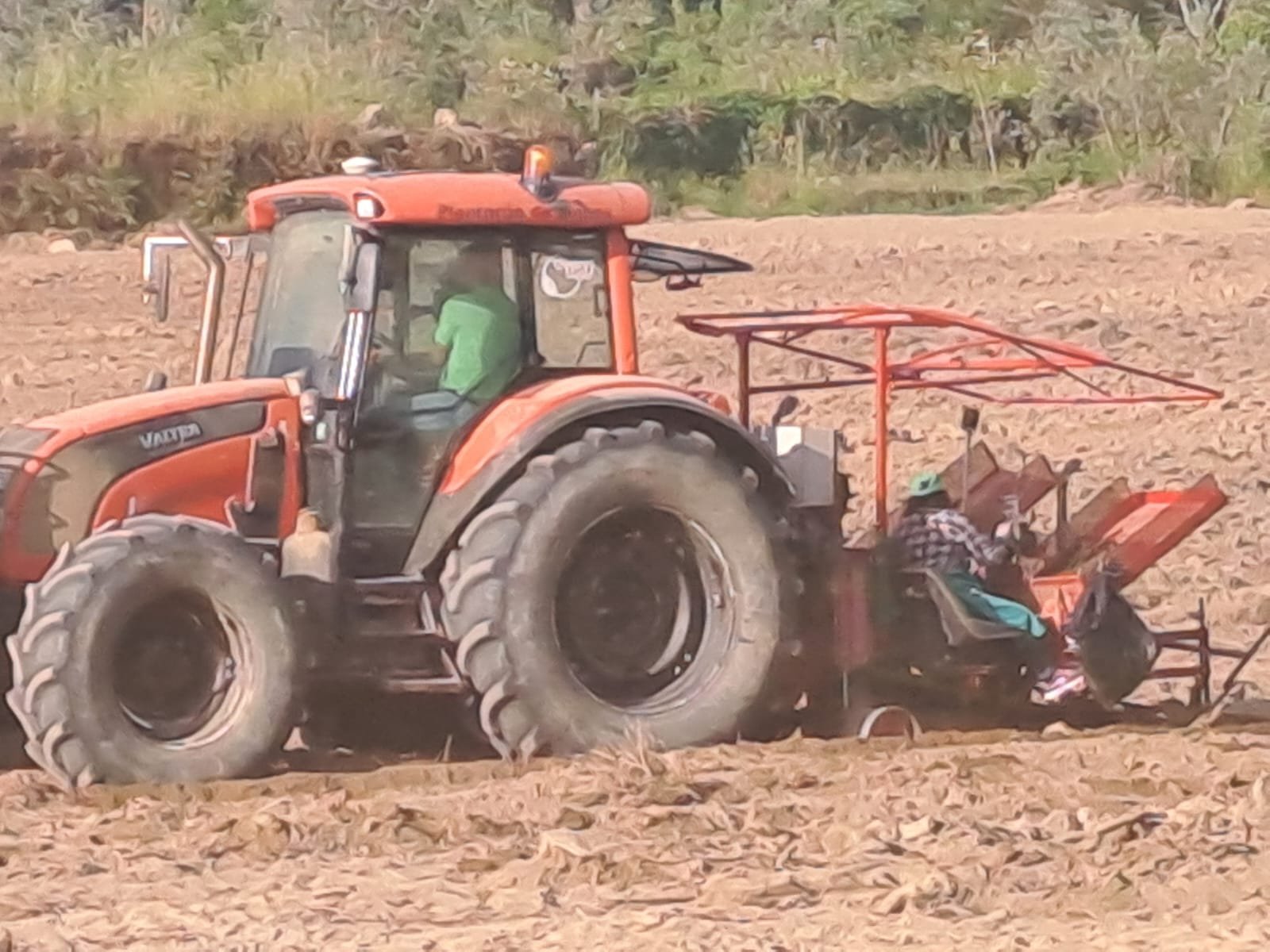Tractor pulling a row-marking implement across the field